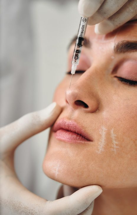 Injections into the skin of the face. A woman came to the clinic for facial skin care.